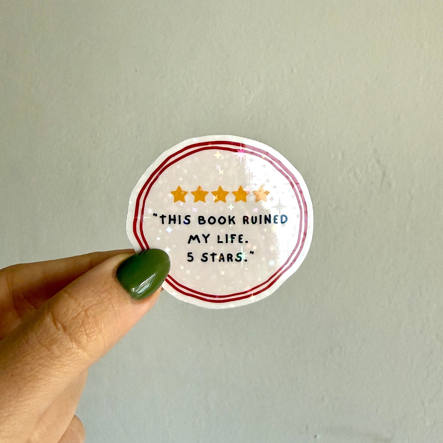 Cute holographic round sticker that says "this book ruined my life. 5 stars." Waterproof, scratch resistant. Perfect for book lovers, journals & laptops.