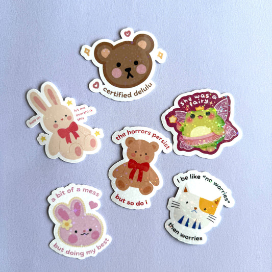  Set of 6 cute relatable animal holographic stickers — bunny, bear, cat, frog & more. Waterproof, scratch resistant. Perfect for journals, laptops & gifting.