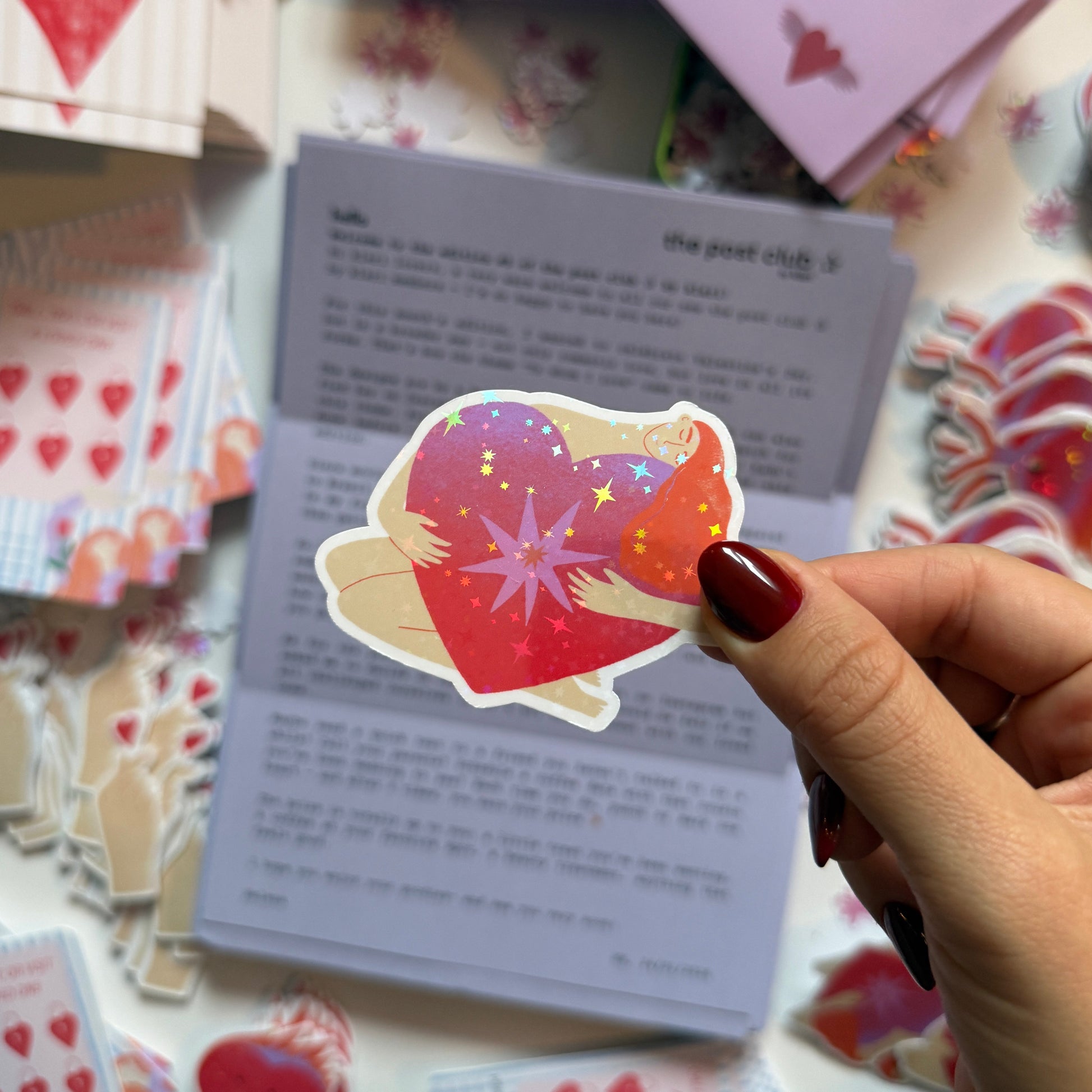 Cute holographic sticker of arms hugging a glowing heart with stars. Waterproof, scratch resistant, approx. 5x5cm. Perfect for journals, laptops & more